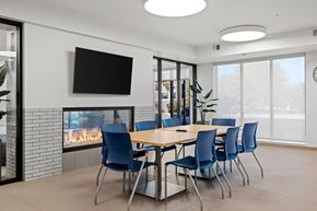 Hopkins apartment for rent - The community room with table, chairs, TV and a fireplace