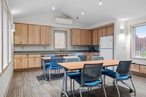 Mahtomedi apartment for rent - a dining room with a table and chairs and a kitchen