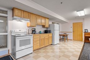 Minneapolis apartment for rent - a kitchen with white appliances and wooden cabinets