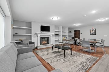 Minneapolis townhouse for rent - a living room with a couch and a table and a fireplace