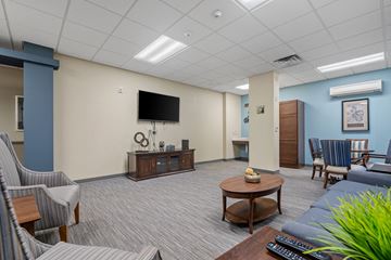 Hopkins apartment for rent - a living room with a couch and chairs and a television