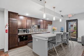 Minneapolis townhouse for rent - a kitchen with a large island and a bar with chairs