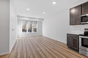 Minneapolis apartment for rent - an empty kitchen and living room with wood flooring and a window