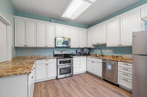 Roseville apartment for rent - a kitchen with white cabinets and marble counter tops