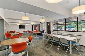 Minneapolis apartment for rent - a dining room with tables and chairs and large windows