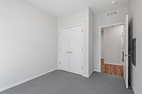Minneapolis apartment for rent - a bedroom with white walls and a door to a closet