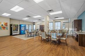 Hopkins apartment for rent - a dining room with tables and chairs and aacistacist in the front of a