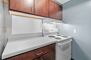 Minneapolis townhouse for rent - an empty kitchen with white appliances and wooden cabinets