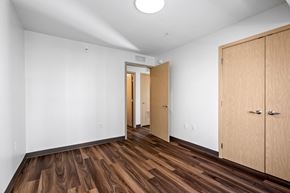 Hopkins apartment for rent - a bedroom with white walls and wood flooring and a closet