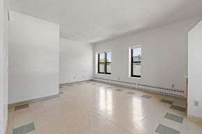 Minneapolis apartment for rent - a spacious living room with white walls and tile floors