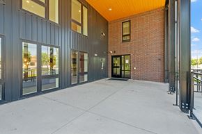 Minneapolis apartment for rent - the preserve at ballantyne commons exterior walkway with glass doors