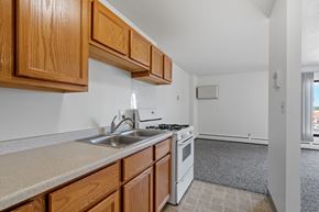 Hopkins apartment for rent - a kitchen with white appliances and wooden cabinets