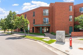 Minneapolis apartment for rent - a red brick building with a sidewalk and a fire hydrant