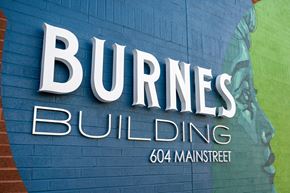 Hopkins apartment for rent - a sign for burns building on a blue brick wall