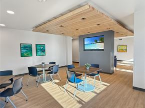 St. Paul apartment for rent - A conference room with a TV screen and chairs.