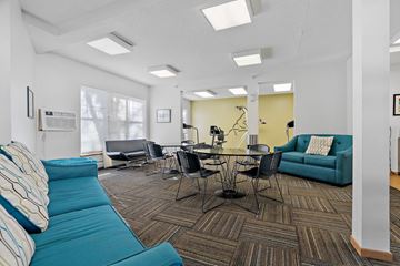 Minneapolis apartment for rent - a living room with blue couches and a table and chairs