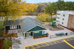 Mahtomedi apartment for rent - an aerial view of a building with a green house and a playground