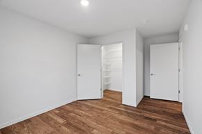 Elk River apartment for rent - a bedroom with white walls and wood floors and a closet