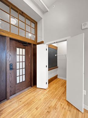 International Falls apartment for rent - a renovated living room with a wooden door and a white closet