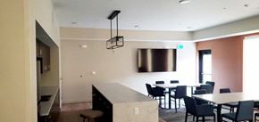 Minneapolis apartment for rent - a dining room with tables and chairs and a tv on the wall
