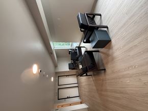 Minneapolis apartment for rent - A wall-mounted speaker system is installed in a room with wooden walls.