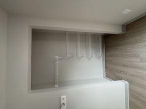 Minneapolis apartment for rent - A white shelf with a mirror above it and a light switch below it.