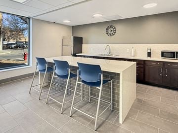 Mankato apartment for rent - A kitchen with a bar area and blue chairs.