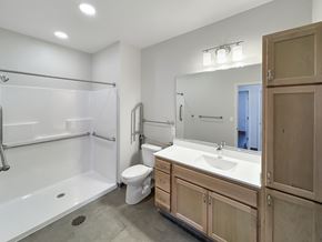 Cottage Grove apartment for rent - A bathroom with a white tub, sink, and toilet.