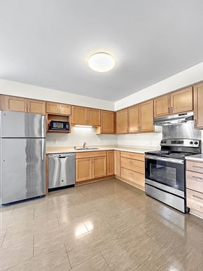 St. Paul apartment for rent - a large kitchen with stainless steel appliances and wooden cabinets
