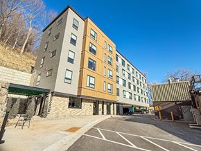 St. Paul apartment for rent - A modern building with a parking lot in front.