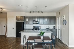 Houston apartment for rent - A kitchen with a table and chairs in front of it.