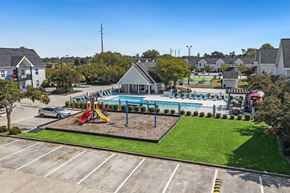 Valdosta apartment for rent - A playground with a slide and swimming pool in the middle of a parking lot.