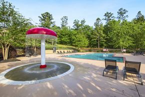 Columbus apartment for rent - a fountain with a red umbrella next to a pool