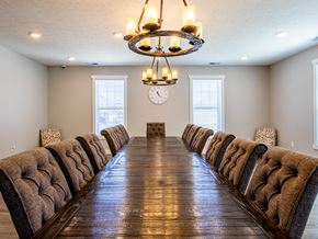 Bridgeport townhouse for rent - a long dining room table with chairs and a clock on the wall