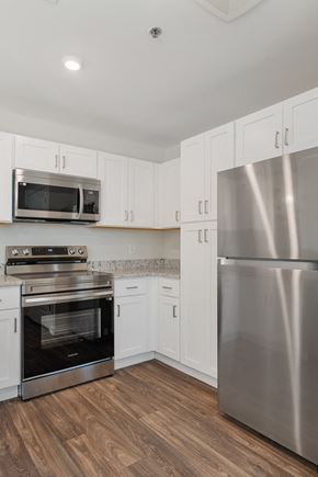 Columbus apartment for rent - a kitchen with stainless steel appliances and white cabinets