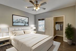 North Little Rock apartment for rent - A bedroom with a large bed and a ceiling fan.
