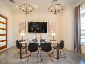 Zachary apartment for rent - a dining room with a glass table and chairs