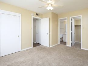 Meridian apartment for rent - an empty living room with three doors and a ceiling fan