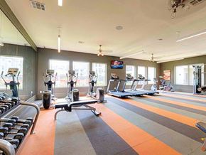 Houston apartment for rent - a gym with cardio equipment and windows
