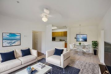 Macon apartment for rent - A living room with a white couch and a blue vase on the coffee table.