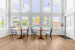 Denham Springs apartment for rent - A dining room with a table and chairs in front of a large window.