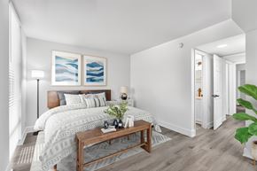 Plantation apartment for rent - A bedroom with a large bed and a wooden coffee table.