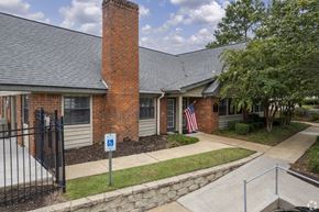 Meridian apartment for rent - a building with a brick chimney and a flag in front of it