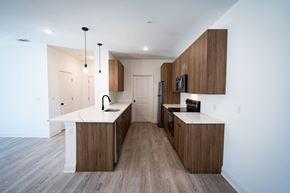 Brunswick apartment for rent - A modern kitchen with wooden cabinets and a white countertop.