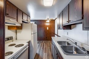 Morgantown apartment for rent - A kitchen with a stove top oven and a refrigerator.