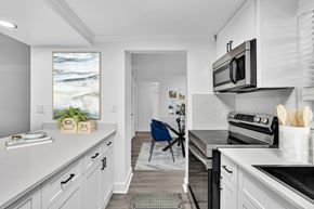Plantation apartment for rent - A kitchen with a white counter top and a blue chair.