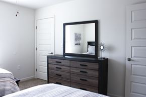 Lyman townhouse for rent - A bedroom with a bed, dresser, and mirror.