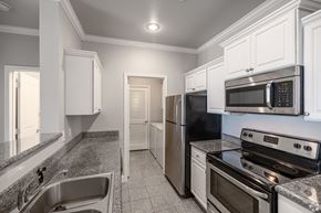 North Little Rock apartment for rent - a kitchen with stainless steel appliances and white cabinets
