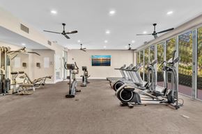 Plantation apartment for rent - A gym with a variety of exercise equipment including treadmills, stationary bikes, and elliptical machines.