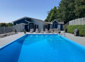 Morgantown apartment for rent - A blue swimming pool in front of a house.